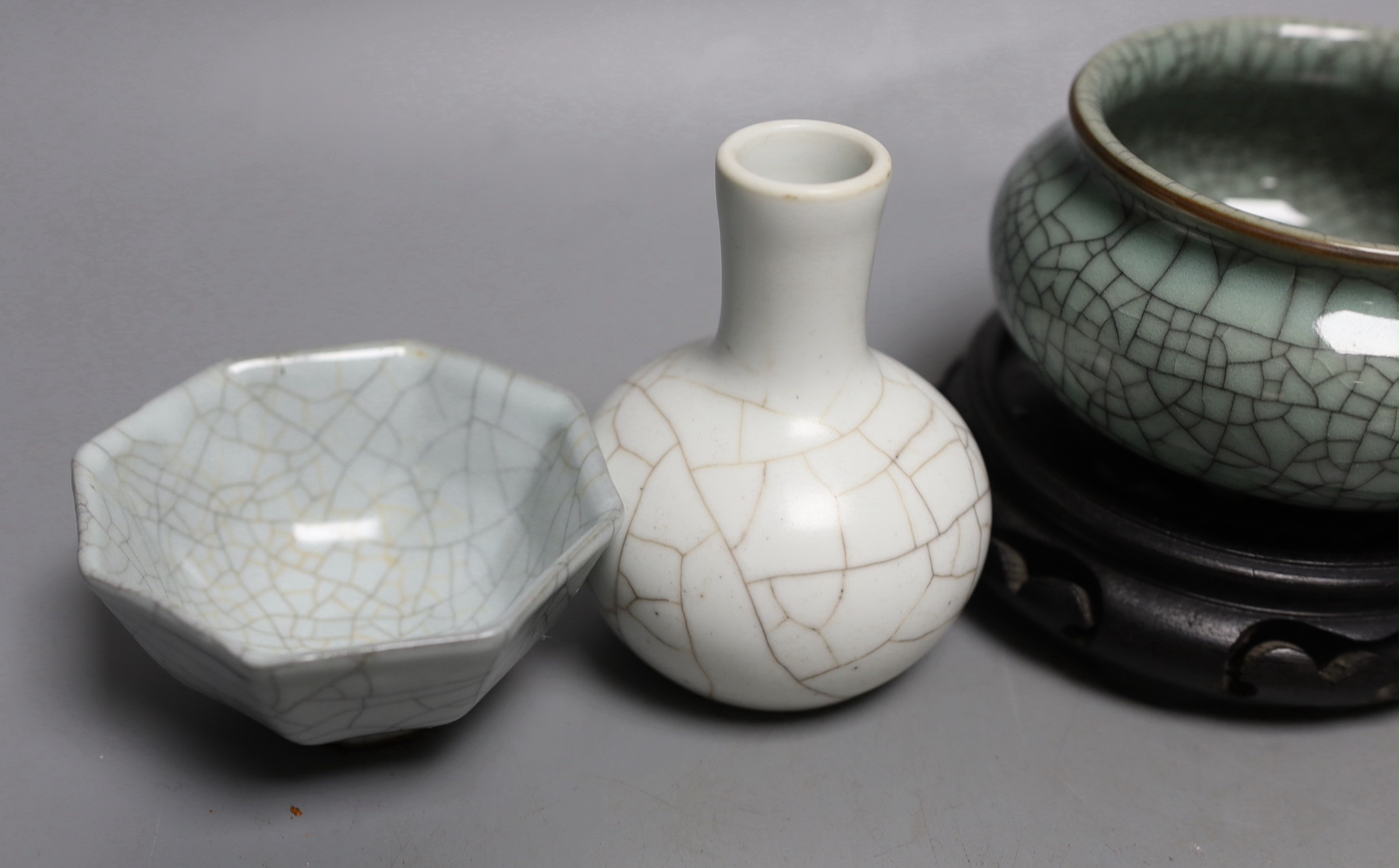 Three Chinese crackle glaze vessels, a Korean celadon pot and a hardwood stand